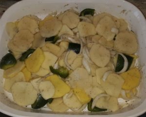 sliced potatoes, onions, and green pepper for Rosemary Ham & Potatoes Recipe